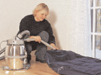 Woman blowing up air mattress with Nilfisk GM80 Residential and Industrial Vacuum Cleaner